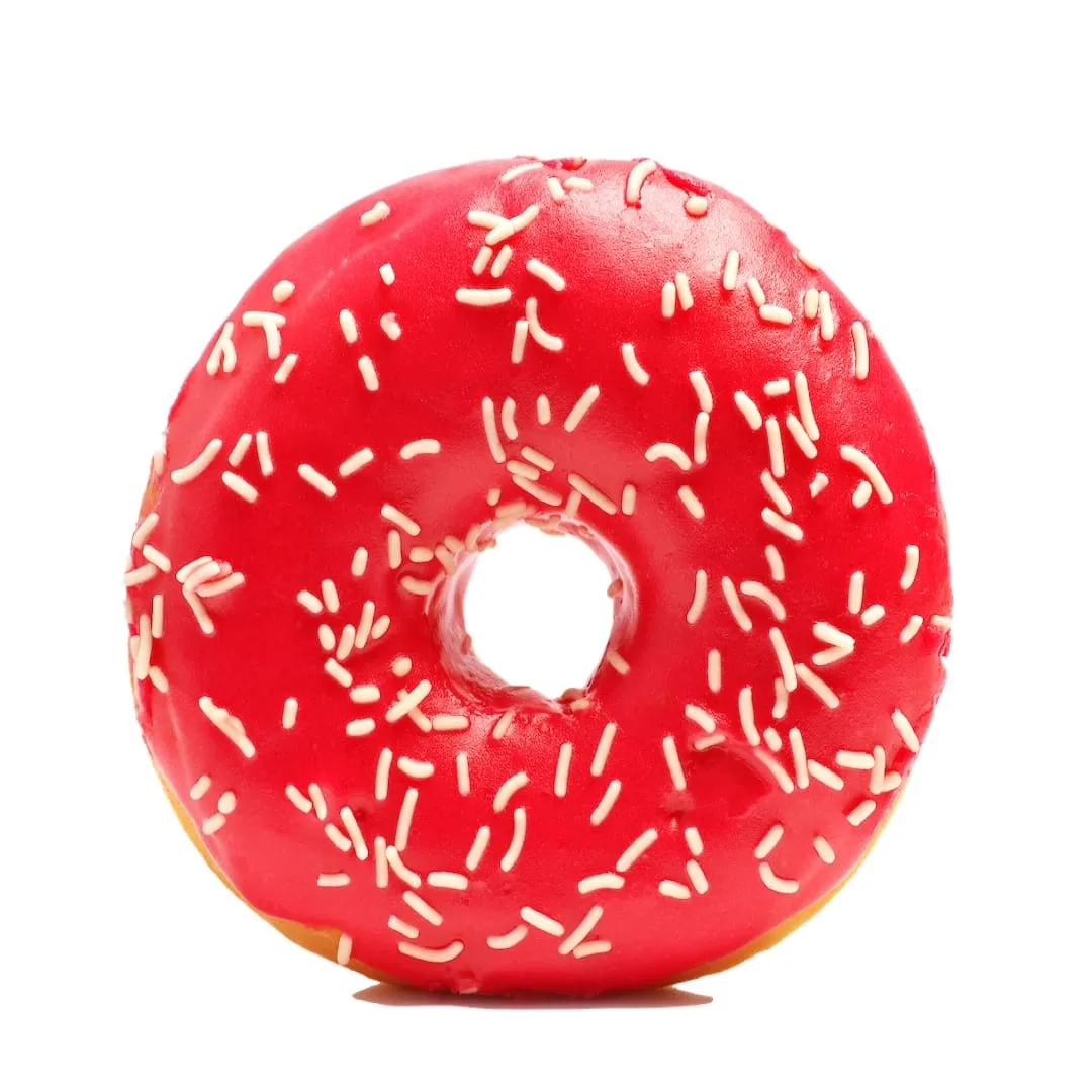 Donut with sprinkles on white background. Red donut isolated on white background
