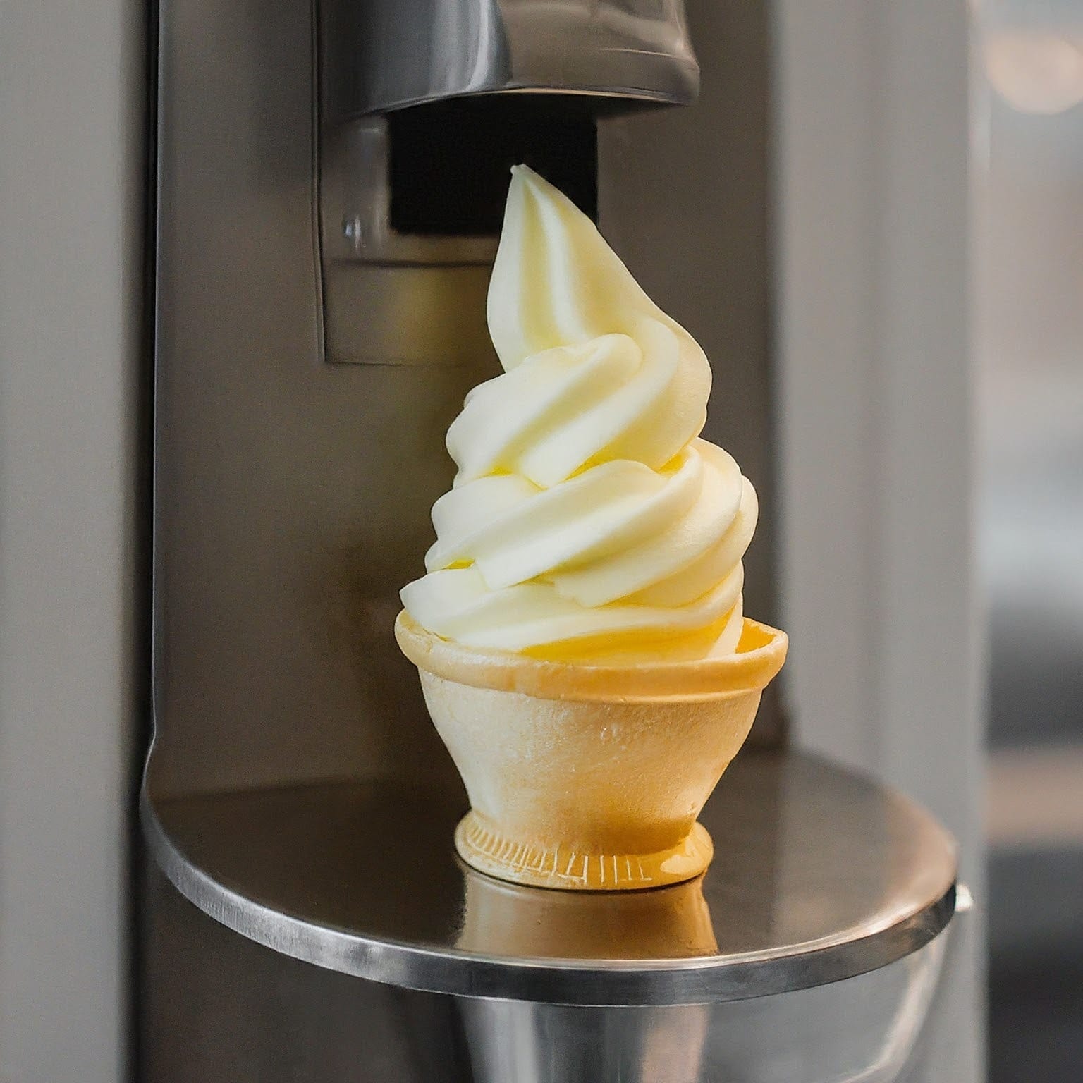 a soft serve ice cream cone on a metal shelf