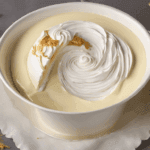 a bowl of food with a swirl of whipped cream